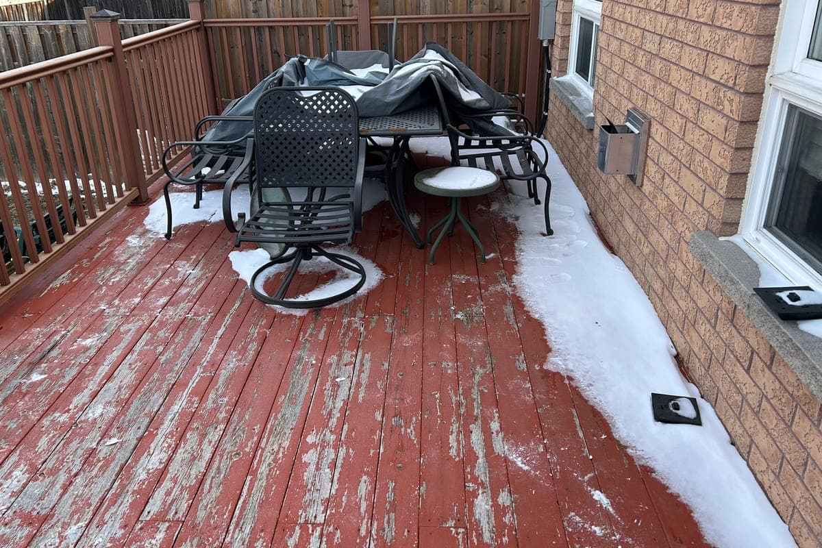 The deck before: peeling red boards and old railings, under snow