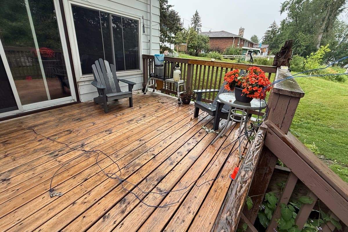 The deck before: weathered boards and old wood railings outside a patio door