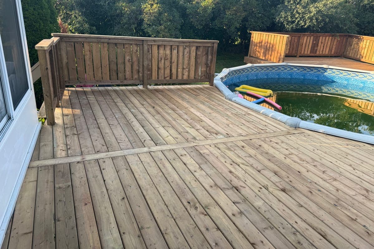 The pool deck at the patio door, new decking running out to the pool edge